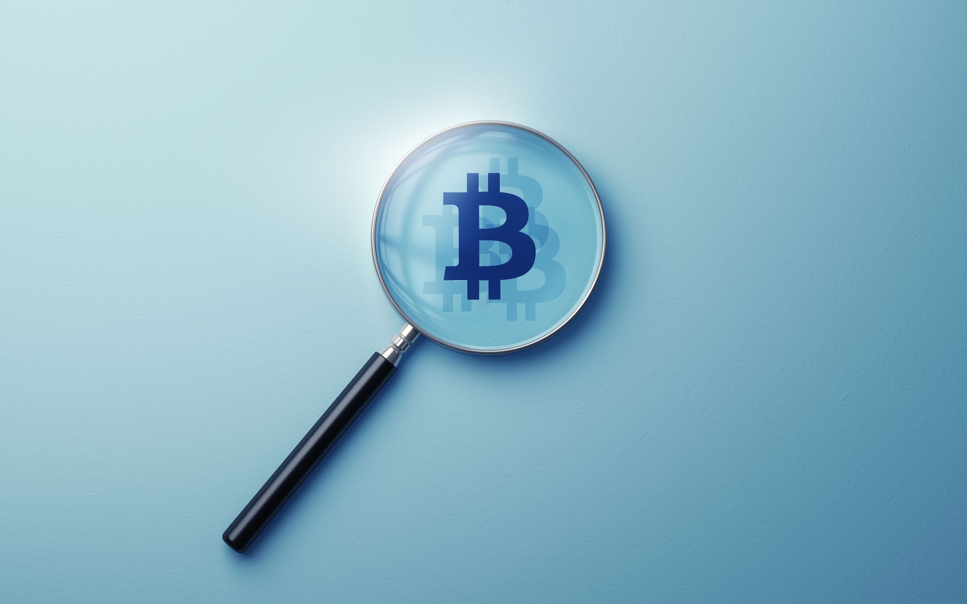 Bitcoin Sign Icon selected with metallic magnifying glass on soft blue background
